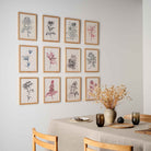 Atelier Auge Gallery wall setup featuring framed hand-drawn botanical illustrations of various flowers in a minimalist and contemporary style.