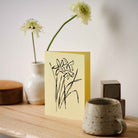 Botanical greeting card featuring a detailed hand-drawn Daffodil flower illustration by Atelier Auge