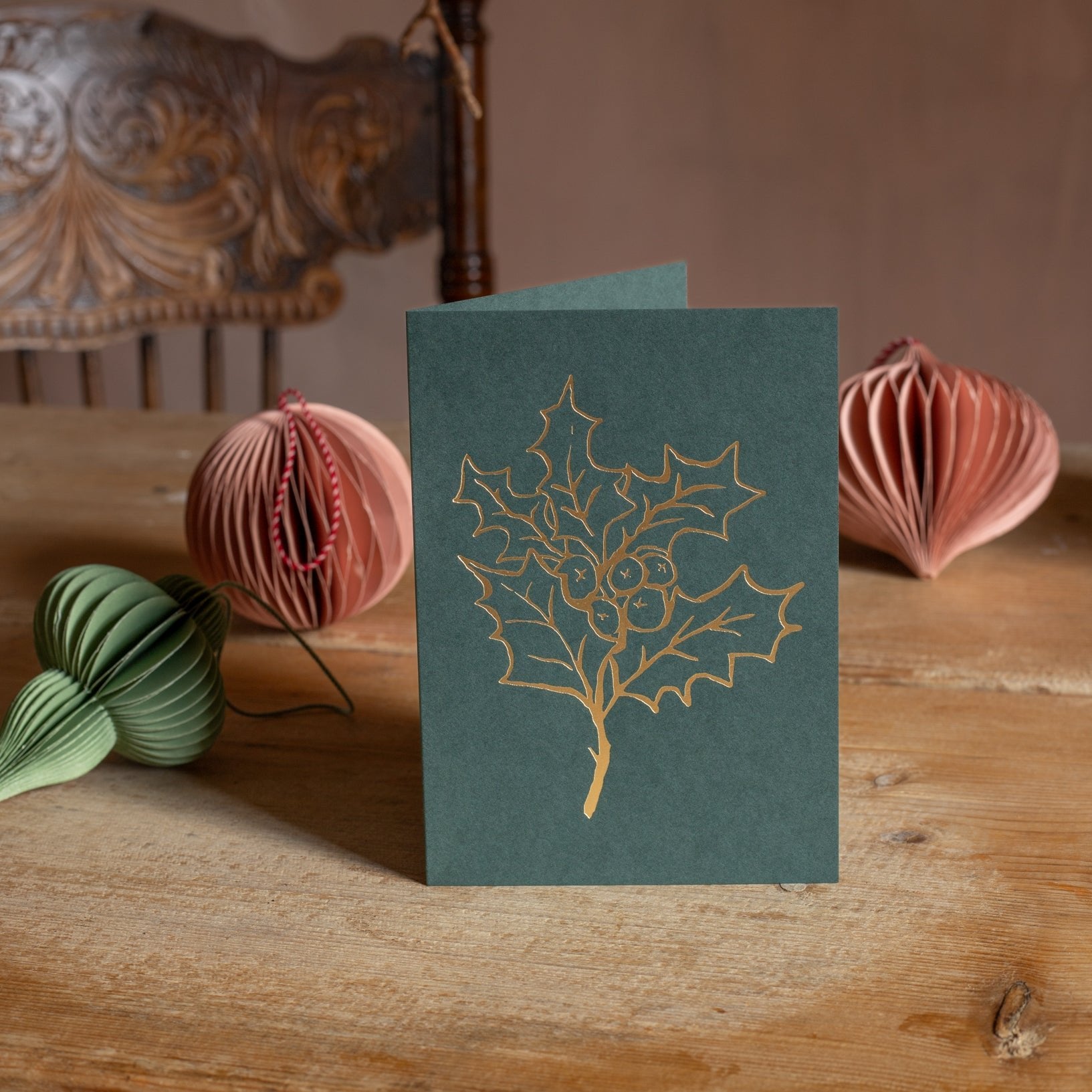 Holly Christmas card with gold line drawing on green cardstock, ideal for holiday greetings and festive wishes.