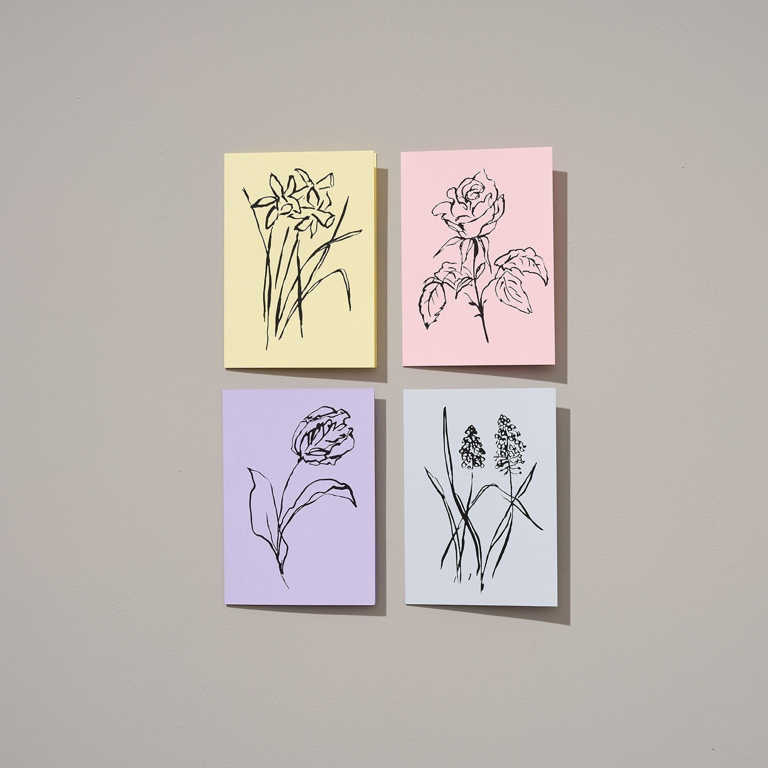 Spring floral pastel greeting card collection featuring delicate illustrations of tulips, daffodils, grape hyacinths, and roses in soft pastel colors, symbolizing renewal and new beginnings.