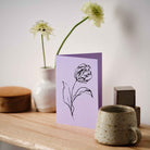 A minimalist Purple art card featuring a hand-drawn Tulip flower sketch with detailed botanical illustration.